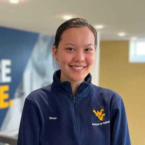 Victoria Weser in a dark blue School of Nursing pull-over