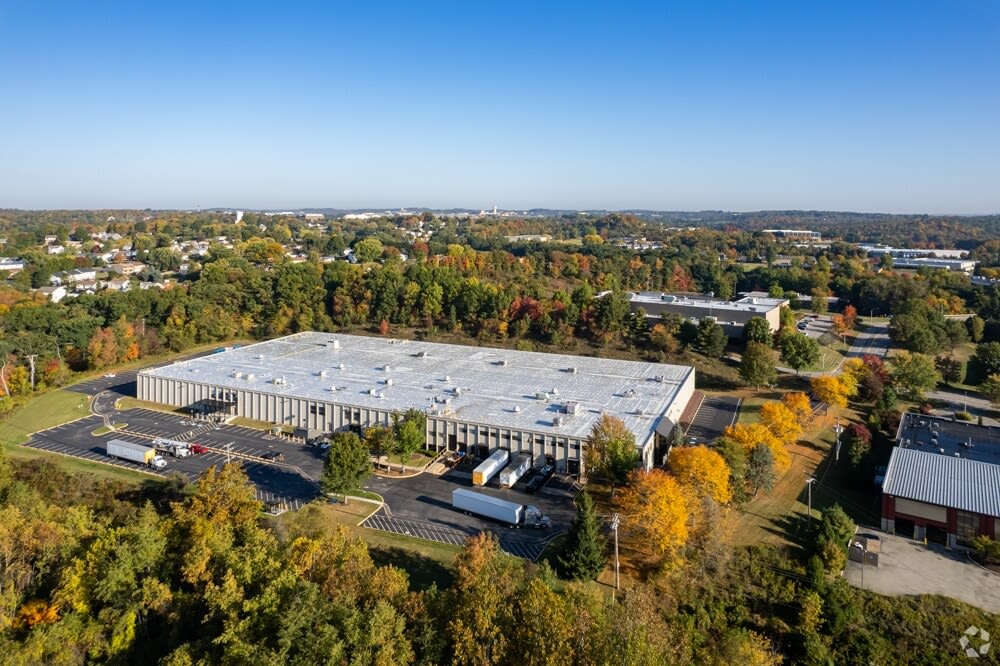 The Beacon Modular plant from the air, a long low building among trees