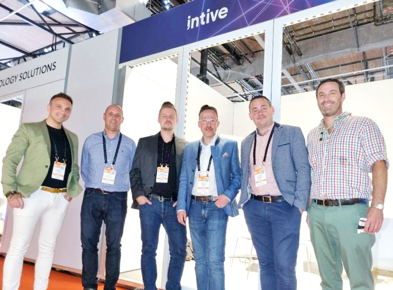 representatives of intive's Technology, Media and Communications Business Unit staying in front of intive's exhibition stand at the International Broadcasting Convention in Amsterdam 