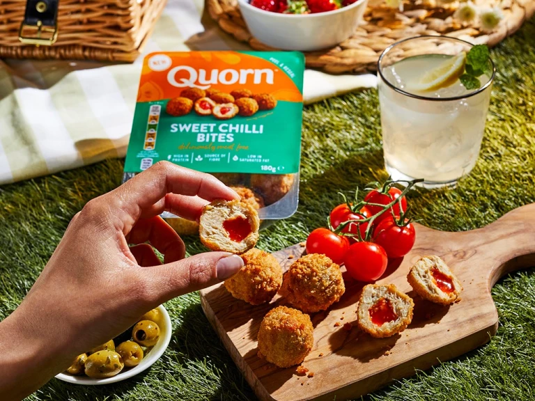 Quorn Sweet Chilli bites on a wooden board with packaging in the background. 