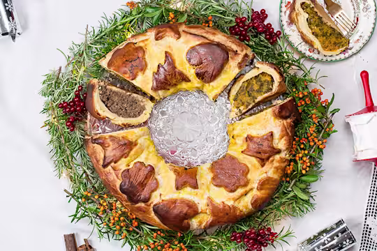 Vegetarian sausage and butternut squash colcannon wreath, with a piece cut opening facing upwards and a piece on the side.