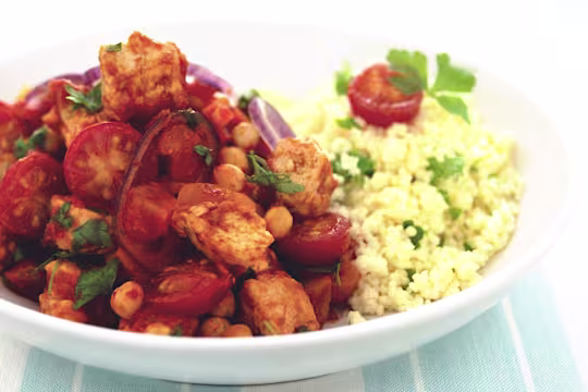 Moroccan Tagine made with Quorn Meatless Pieces, chickpeas and tomatoes served with couscous in a white dish