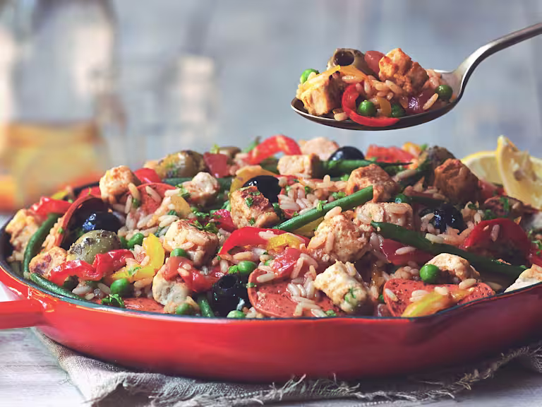 Vegetarian paella recipe made with Quorn Vegan Pieces, Quorn Vegan Pepperoni Slices and vegetables served in a red pan