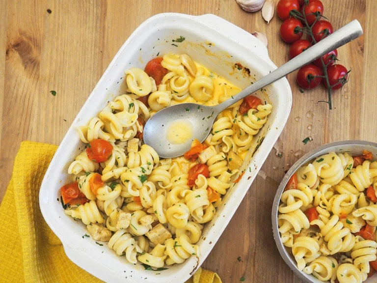 Baking dish of pasta with cherry tomatoes and baked quorn pieces; sprinkled with herbs