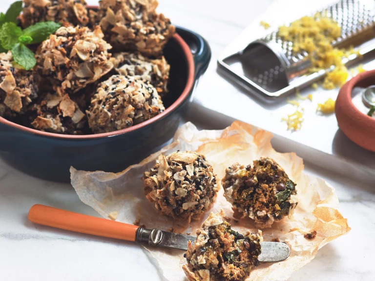 Vegetarian party food of Quorn Mince and Lentil Meatball bites served in a bowl with a couple on the side and one cut in half