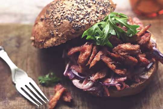 Quorn Vegetarian BBQ Pulled Quorn Fillets on top of coleslaw between two brioche bread buns.