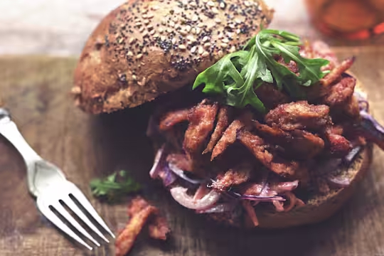 Quorn Vegetarian BBQ Pulled Quorn Fillets on top of coleslaw between two brioche bread buns.