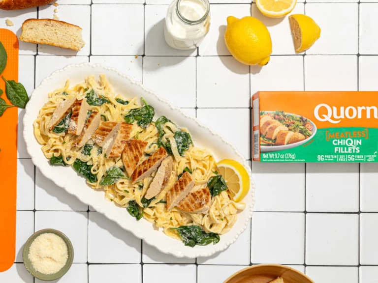 Quorn Vegetarian Chicken Florentine served with pasta with a box of Quorn ChiQin Fillets on the side.