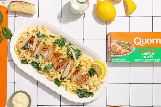 Quorn Vegetarian Chicken Florentine served with pasta with a box of Quorn ChiQin Fillets on the side.