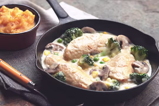Quorn Vegetarian Chicken Casserole with cream, made with Quorn fillets, onions, mushrooms, peas and broccoli, served in a casserole dish