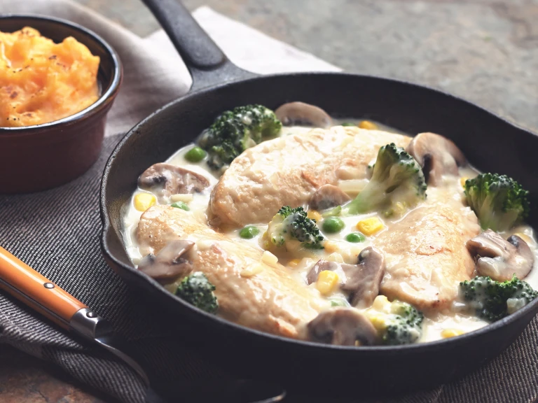 Quorn Vegetarian Chicken Casserole with cream, made with Quorn fillets, onions, mushrooms, peas and broccoli, served in a casserole dish