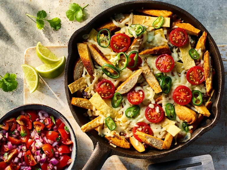 Vegetarian Migas with Quorn Fillets visible on the top of the dish served with a side of salsa. 