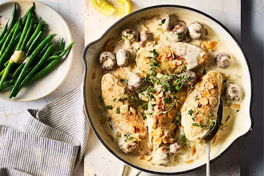 Quorn Fillets in a vegetarian fricassee stew with mushrooms and a side dish of green beans with butter.