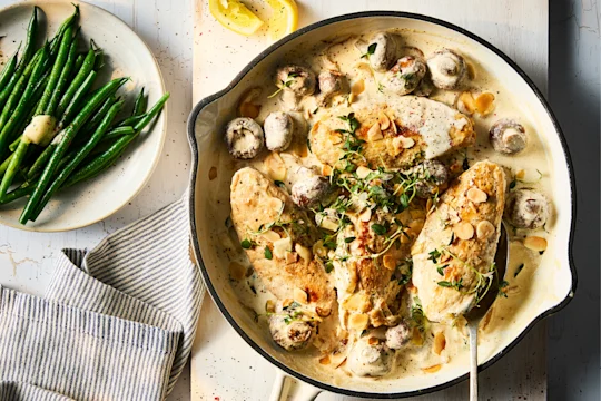 Quorn Fillets in a vegetarian fricassee stew with mushrooms and a side dish of green beans with butter.