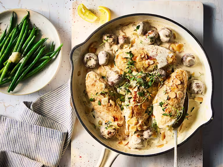 Quorn Fillets in a vegetarian fricassee stew with mushrooms and a side dish of green beans with butter.