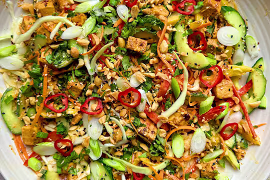 Vegetarian chicken satay salad with Quorn Pieces, vegetables and peanut dressing on a plate