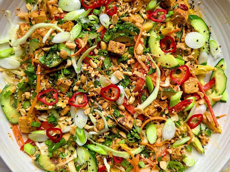 Vegetarian chicken satay salad with Quorn Pieces, vegetables and peanut dressing on a plate