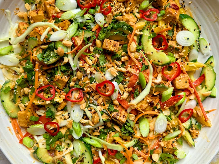 Vegetarian chicken satay salad with Quorn Pieces, vegetables and peanut dressing on a plate