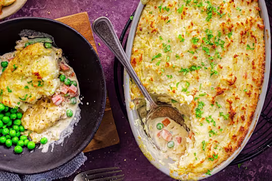 Vegetarian Shepherd's Pie with a slice served in a bowl alongside peas. Quorn Crispy Nuggets packaging displayed.
