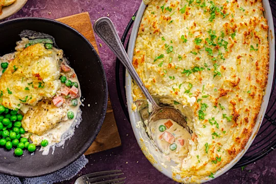Vegetarian Shepherd's Pie with a slice served in a bowl alongside peas. Quorn Crispy Nuggets packaging displayed.