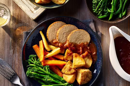 Quorn Vegetarian Beef Roast Dinner served alongside Air Fryer Roast Potatoes, carrots and broccoli.