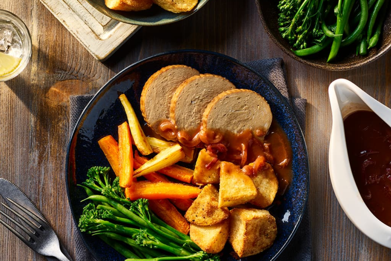 Quorn Vegetarian Beef Roast Dinner served alongside Air Fryer Roast Potatoes, carrots and broccoli.