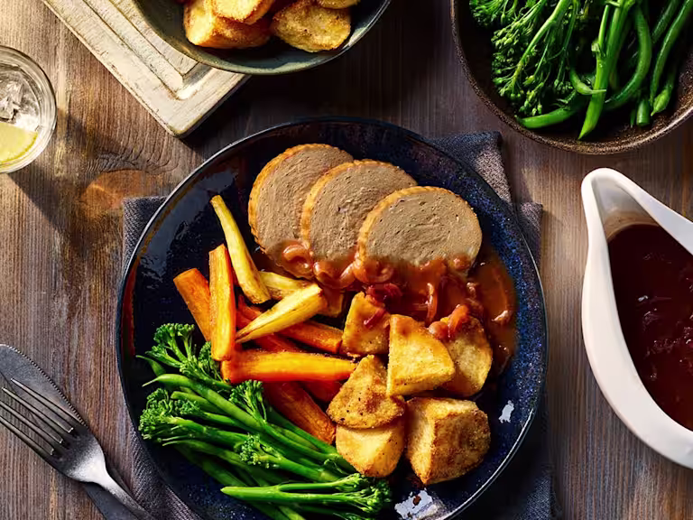 Quorn Vegetarian Beef Roast Dinner served alongside Air Fryer Roast Potatoes, carrots and broccoli.