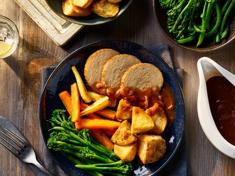 Quorn Vegetarian Beef Roast Dinner served alongside Air Fryer Roast Potatoes, carrots and broccoli.