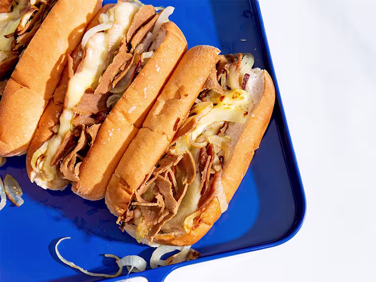 Vegetarian Philly Cheesesteak Sandwich with Quorn Roast Beef Style Slices on a blue tray