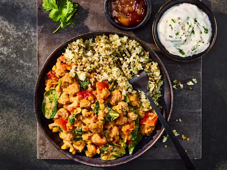A tasty bowl of Quorn Mince Keema Dal served with Cauliflower Rice, chutney, and a yogurt dip.