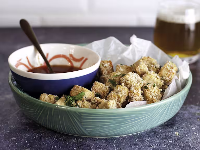 A bowl of popcorn Quorn Vegan Pieces with a bowl of buffalo sauce on the side.