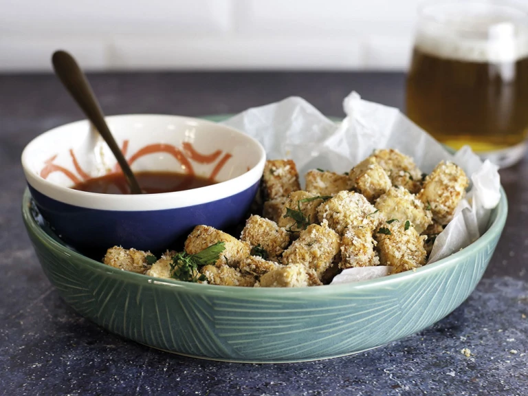 A bowl of popcorn Quorn Vegan Pieces with a bowl of buffalo sauce on the side.