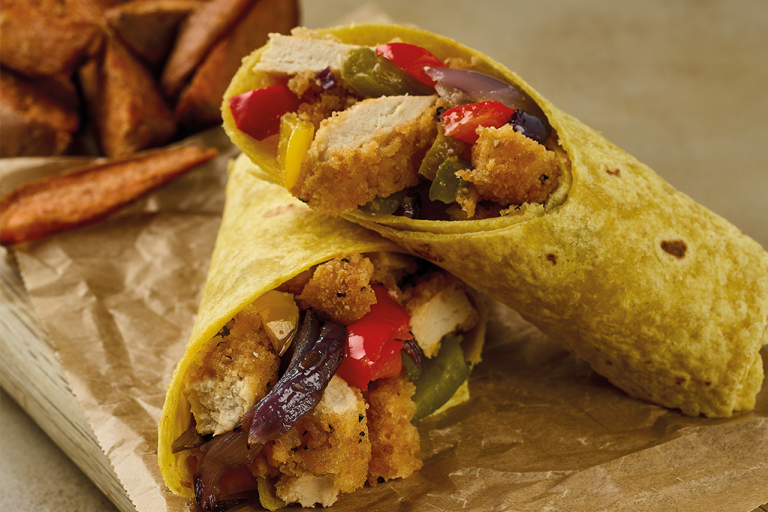 Two wraps filled with sliced Quorn Southern Fried Burgers, roasted vegetables, rocket, and a yoghurt spread.