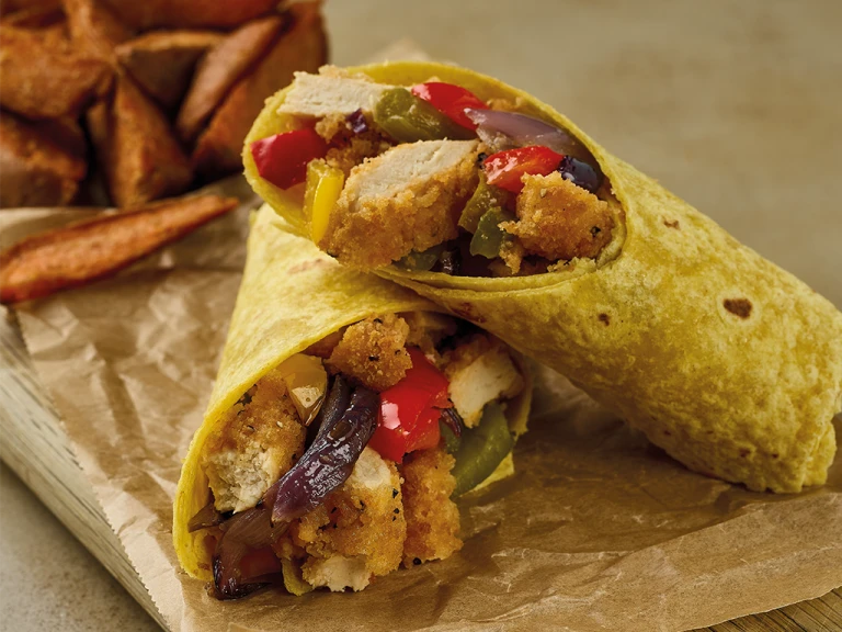 Two wraps filled with sliced Quorn Southern Fried Burgers, roasted vegetables, rocket, and a yoghurt spread.