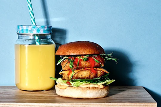 Two Quorn Southern Fried Burgers in a burger bun with salad and sriracha mayo