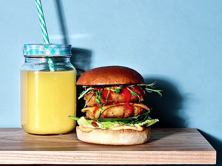Two Quorn Southern Fried Burgers in a burger bun with salad and sriracha mayo