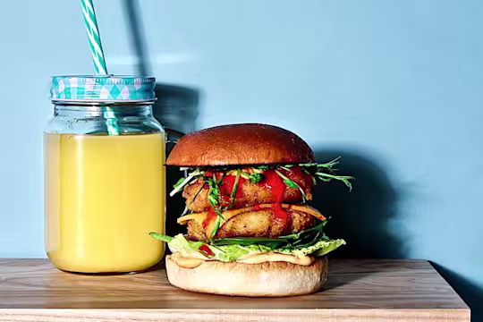 Two Quorn Southern Fried Burgers in a burger bun with salad and sriracha mayo