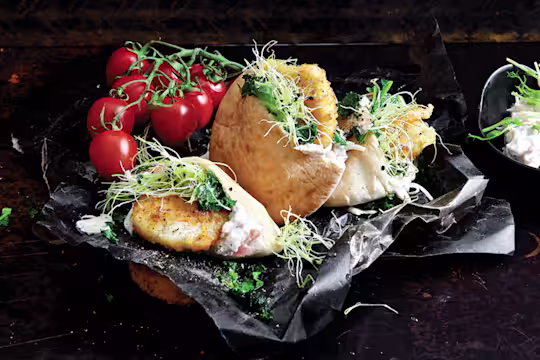 Easy healthy meal made with Quorn Escalopes stuffed in a pita with mozzarella and pesto with a side of coleslaw and tomatoes