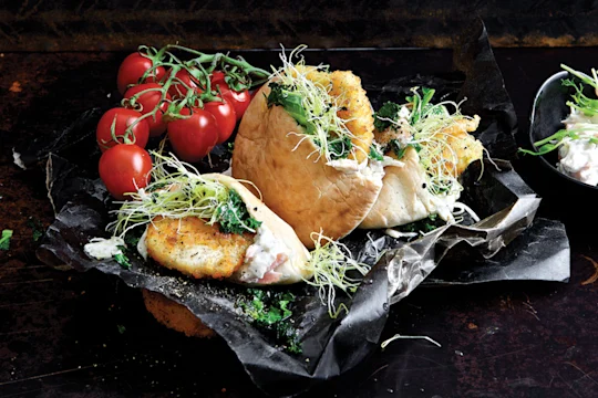 Easy healthy meal made with Quorn Escalopes stuffed in a pita with mozzarella and pesto with a side of coleslaw and tomatoes