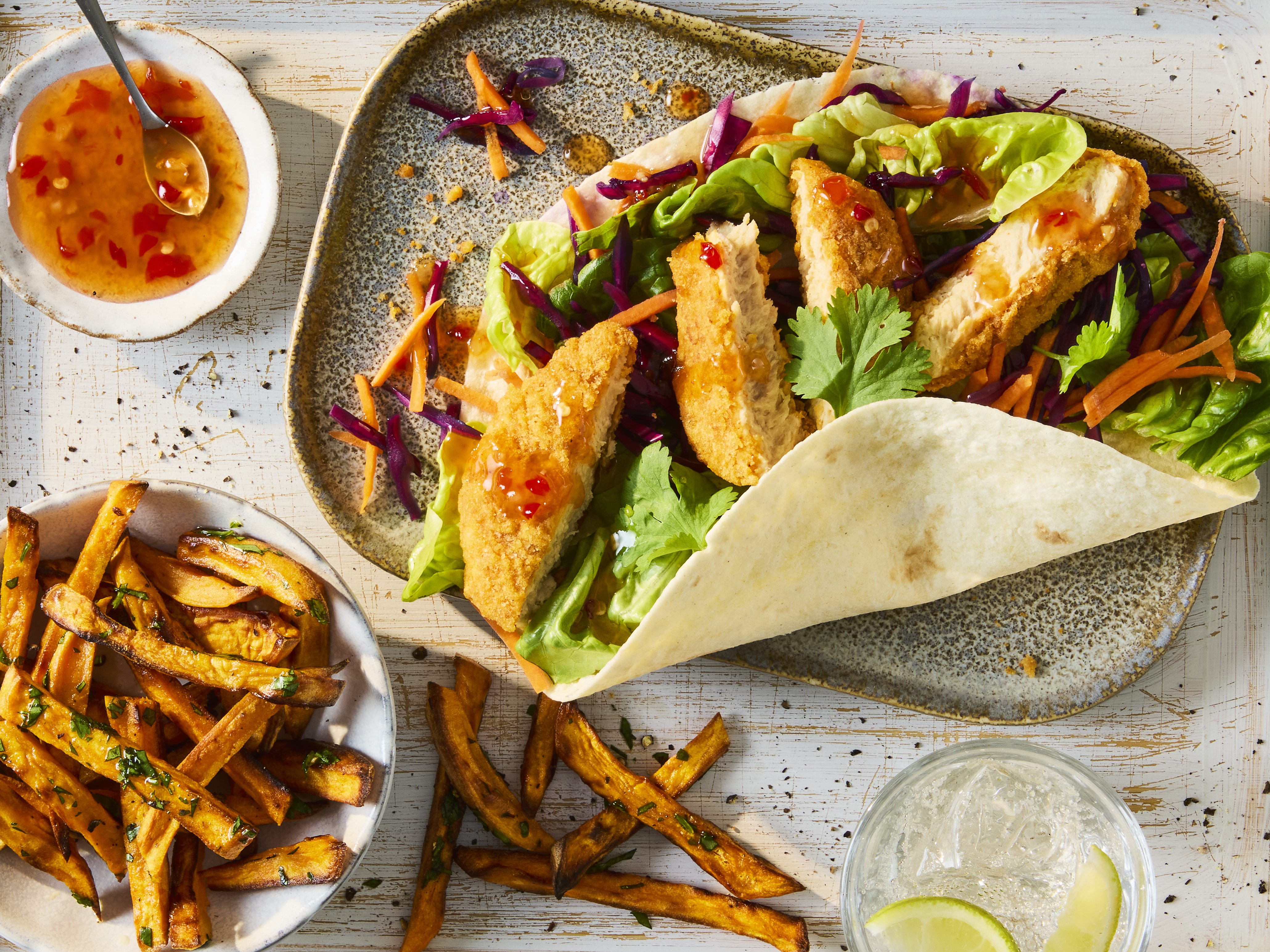 Quorn Hot & Spicy Bites in a tortilla wrap with little gem lettuce and coleslaw, served with fries and sweet chilli sauce.