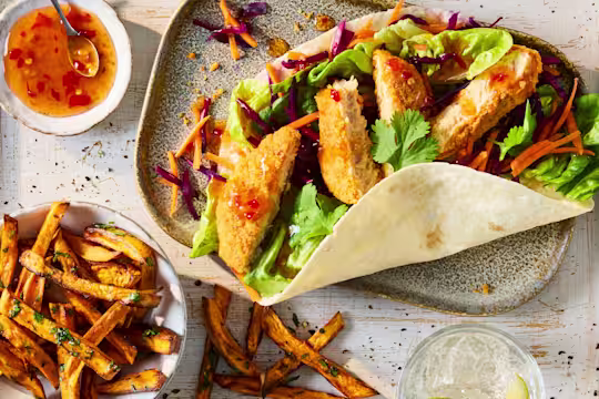 Quorn Hot & Spicy Bites in a tortilla wrap with little gem lettuce and coleslaw, served with fries and sweet chilli sauce.