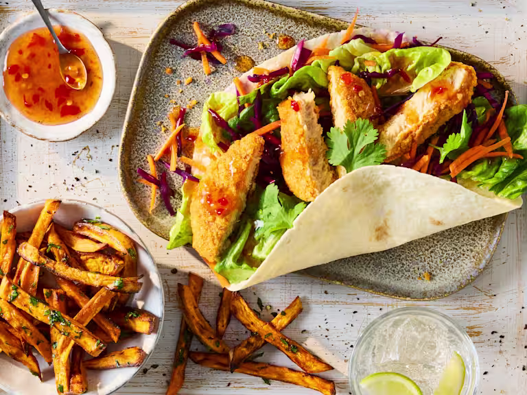 Quorn Hot & Spicy Bites in a tortilla wrap with little gem lettuce and coleslaw, served with fries and sweet chilli sauce.