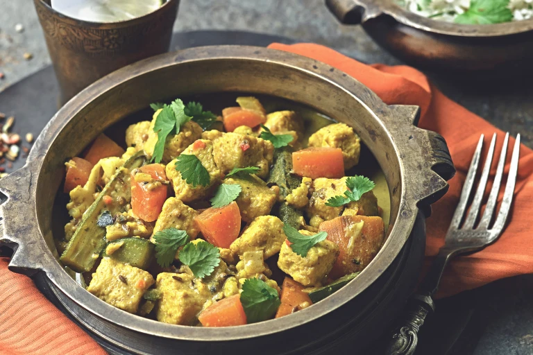 A bowl of Keralan curry made Quorn pieces, vegetables and coconut milk.