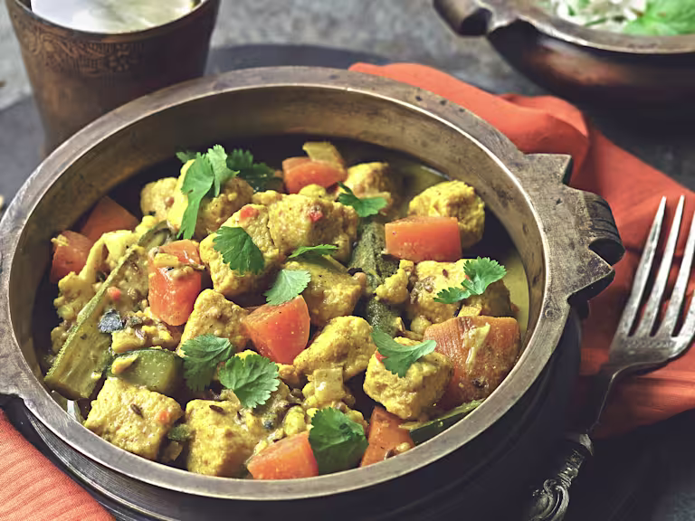 A bowl of Keralan curry made Quorn pieces, vegetables and coconut milk.