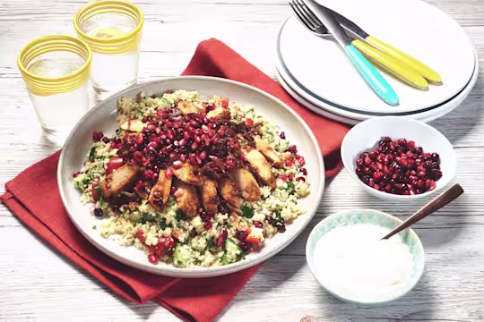 Moroccan vegetarian recipe made with Quorn Fillets served with green couscous topped with pomegranate, served in a white dish