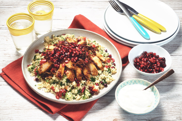Moroccan vegetarian recipe made with Quorn Vegan Fillets served with green couscous topped with pomegranate, served in a white dish
