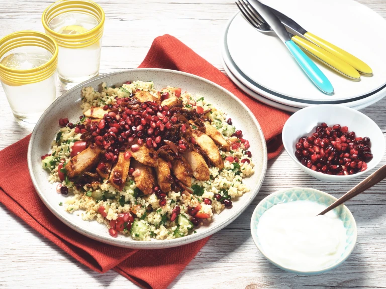 Moroccan vegetarian recipe made with Quorn Fillets served with green couscous topped with pomegranate, served in a white dish