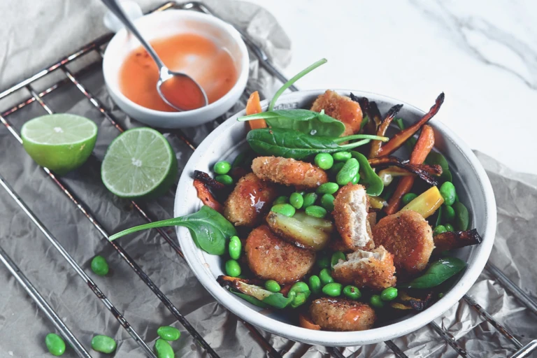 Quorn Vegan Nugget Bowl, made with Quorn Vegan Nuggets, edamame beans, spinach, parsnip and carrots, served with tomato dip and lime.