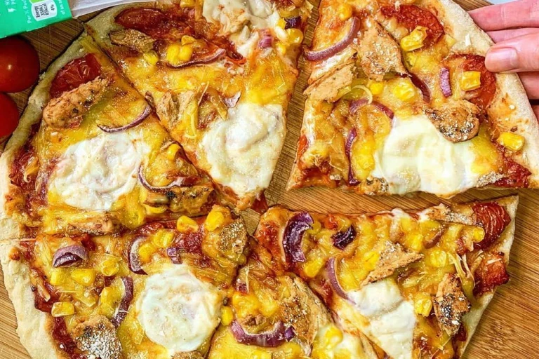 Vegan pizzas topped with vegan cheese, Quorn Sweet Chilli Mini Fillets, onions and sweetcorn.