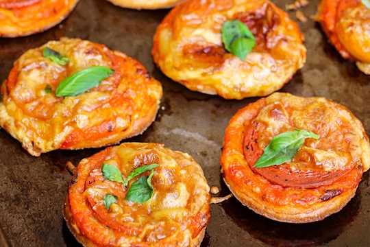 Four Mini Puff Pastry Vegan Pepperoni Pizzas.